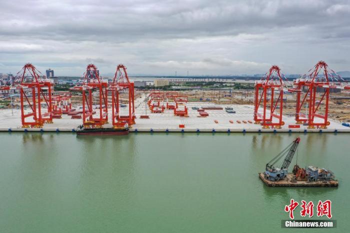 6月23日，廣東省廣州市，廣州港南沙四期碼頭實(shí)船聯(lián)合調(diào)試成功。該碼頭采用“單小車自動化岸橋、北斗導(dǎo)航無人駕駛智能集卡、堆場水平布置側(cè)面裝卸、港區(qū)全自動化”運(yùn)作方案，是粵港澳大灣區(qū)首個全自動化碼頭。(無人機(jī)照片) <a target='_blank' href='http://www.chinanews.com/'>中新社</a>記者 陳驥旻 攝 