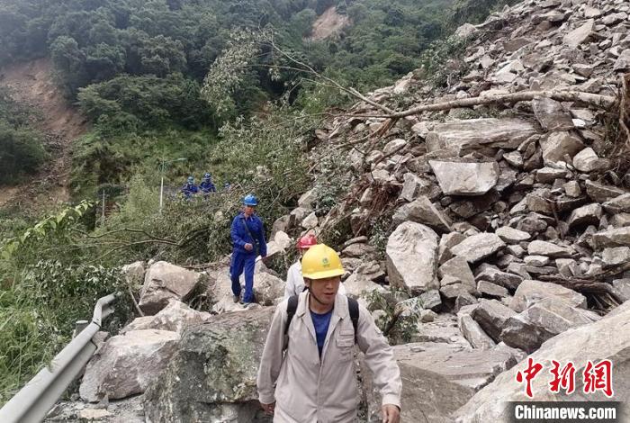 電力搶險(xiǎn)人員徒步通過(guò)垮塌路段。　四川電力供圖