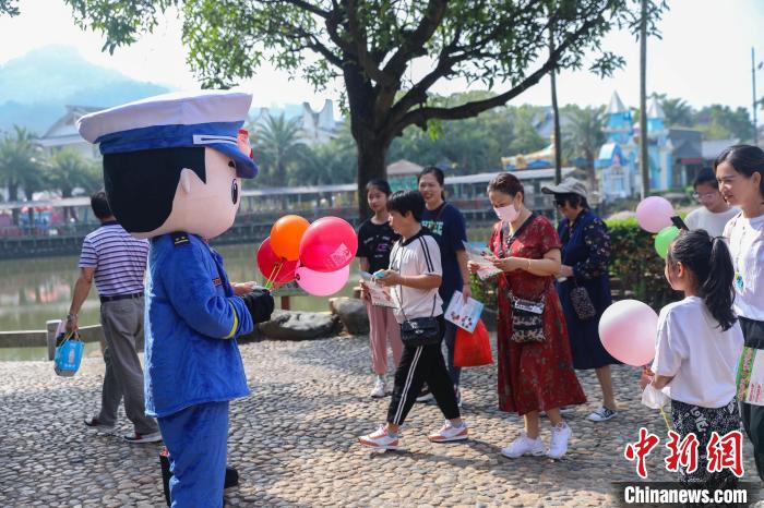 宣傳玩偶正在給游客贈(zèng)送宣傳小禮品?！±钤x 攝