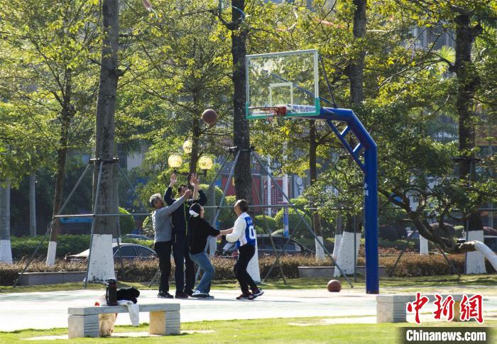圖為市民、游客在防城港市公園廣場打籃球。　翟李強 攝