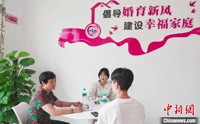 圖為職業(yè)“媒婆”邱細(xì)花在自己的工作室內(nèi)為一對(duì)新人講解正確的婚俗觀念?！”R夢(mèng)夢(mèng) 攝