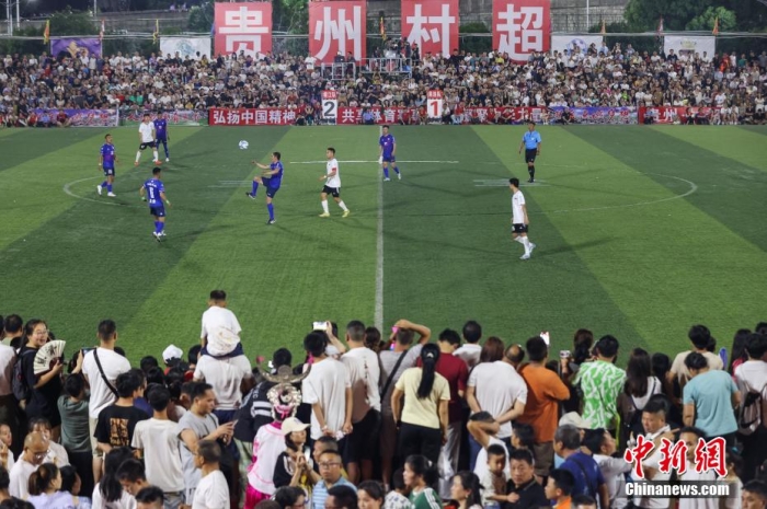 6月23日晚，在貴州省黔東南苗族侗族自治州榕江縣城北新區(qū)田徑足球場(chǎng)進(jìn)行的“榕江縣(三寶侗寨)和美鄉(xiāng)村足球超級(jí)聯(lián)賽(村超)”中，來(lái)自青海省果洛藏族自治州格薩爾王足球隊(duì)和榕江縣村超聯(lián)隊(duì)進(jìn)行了友誼賽，吸引上萬(wàn)民眾前來(lái)觀賽。最終，兩隊(duì)以2：2戰(zhàn)成平手。圖為果洛藏族自治州格薩爾王足球隊(duì)(藍(lán)衣)和榕江縣村超聯(lián)隊(duì)在比賽中。瞿宏倫 攝