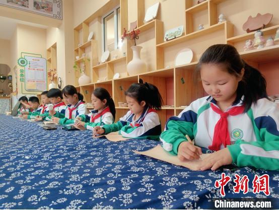 圖為康巴什區(qū)第四小學(xué)的學(xué)生在學(xué)習(xí)制作皮雕作品。　呂京供圖