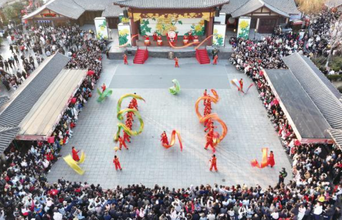 春節(jié)假期，各地紛紛“亮家底”“出大招”，舉辦豐富多彩的文旅活動，吸引市民和游客參觀游覽，體驗(yàn)十足年味。圖為日前，游客在河南省開封市清明上河園景區(qū)觀看表演。新華社發(fā)（譚豫增 攝）